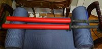 Two red foam swords on blue upholstered seat