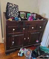 Front view showing drawers, doors, knobs, color and finish