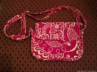 Front view of fuchsia and cream quilted crossbody bag showing overall design and adjustable strap