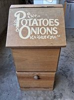 front view of wooden potato & onion bin showing lettering