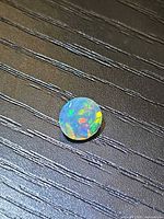 Top view of round faceted Ethiopian opal showing play of color