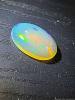 Oblique view of opal showing multicolored play-of-color on cabochon