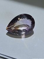 Pear-cut Ametrine front view showing bi-color zoning