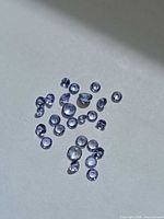 Group of round violet-blue Tanzanite stones on white background
