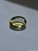 Oblique view of oval lemon citrine showing table and crown facets