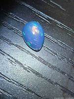 Pear cabochon opal showing play of colour