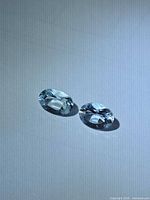 Both aquamarine stones top view showing matching oval cut