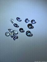Close-up of all Tanzanite stones on white background