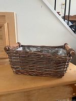 Rectangular wicker basket with plastic liner, wooden side handles