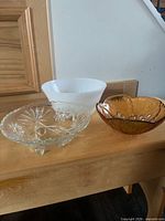 Three bowls: milk glass, amber glass, clear footed glass