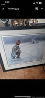 Overall view of the framed ice fishing print showing artwork, matting, and frame