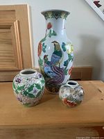 Vase and two ginger jars displayed together