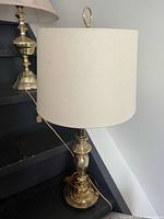 Brass table lamp with off-white drum shade and cord