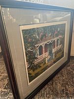 Full view of framed print standing on floor, showing frame, mat, and overall artwork