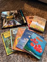 All nine children’s books arranged on carpet showing covers