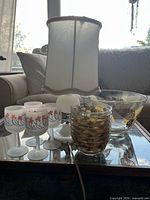 Group view showing lamp, salad bowl, four wine glasses, tumbler