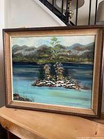 Full view of framed oil landscape painting with visible signature and frame