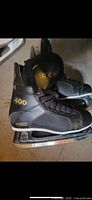 Side view of both CCM 400 skates showing size, branding and wear