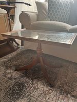 Full view of vintage glass top wood pedestal side table