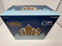 Retail box with branding, model name, and LED feature note