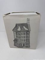 Printed box front showing grayscale image of Nephew Fred's Flat building