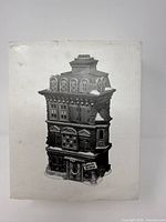 Front of box showing grayscale illustration of building