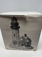 Front of original box showing lighthouse image