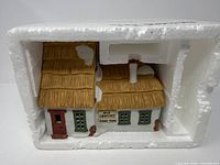 Front view of Bob Cratchit Tiny Tim house in styrofoam insert