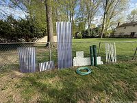 Group view of panels, lattice, mesh rolls, hose, stakes