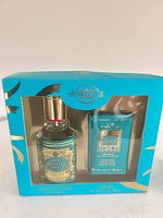 Front of sealed teal gift box showing cologne bottle and cream soap