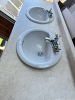 full view of vanity top showing both sinks and faucets