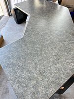 Angled view of L-shaped countertop showing patterned laminate and cut-out