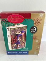 Front of retail box showing Hallmark Heirloom Nancy Drew ornament artwork and 75th Anniversary badge