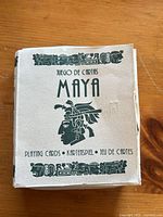 Front of folded box labelled "Juego de Cartas Maya" with Mayan profile graphic