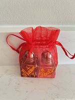 Front view of both shakers inside red bag