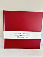 front view of red leather scrapbook album with belly band