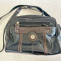 Front view showing bag, trim, logo button, strap