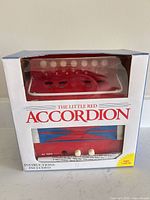 Boxed accordion front view showing product name and window