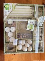 Front view of sealed 46-piece candle set showing tapers, tea lights, floating candles, votives and glass holders