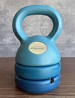 Front view of assembled kettlebell showing Empower logo and stacked weights