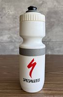 Front view of white Specialized water bottle with red logo