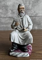 Front view of porcelain seated doctor figurine