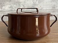 Side view of brown enamel casserole with lid attached