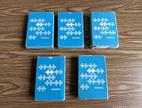 Five blue Healthco card boxes on wood surface