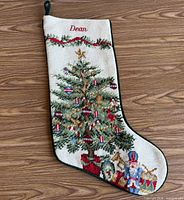 Front view of needlepoint Christmas stocking with tree design and name "Dean"