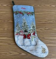 Front of stocking with needlepoint design and name