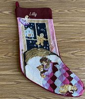 Front view showing needlepoint design, name Lilly, overall condition