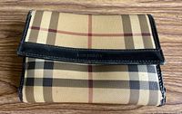 Front view of Burberry plaid wallet with logo tab