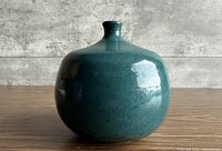 front view of teal blue studio pottery vase