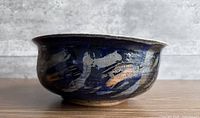 Side profile of bowl showing dark blue glaze and brushstroke decoration